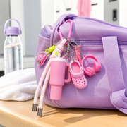 Pink sports charm attached to a purple gym bag